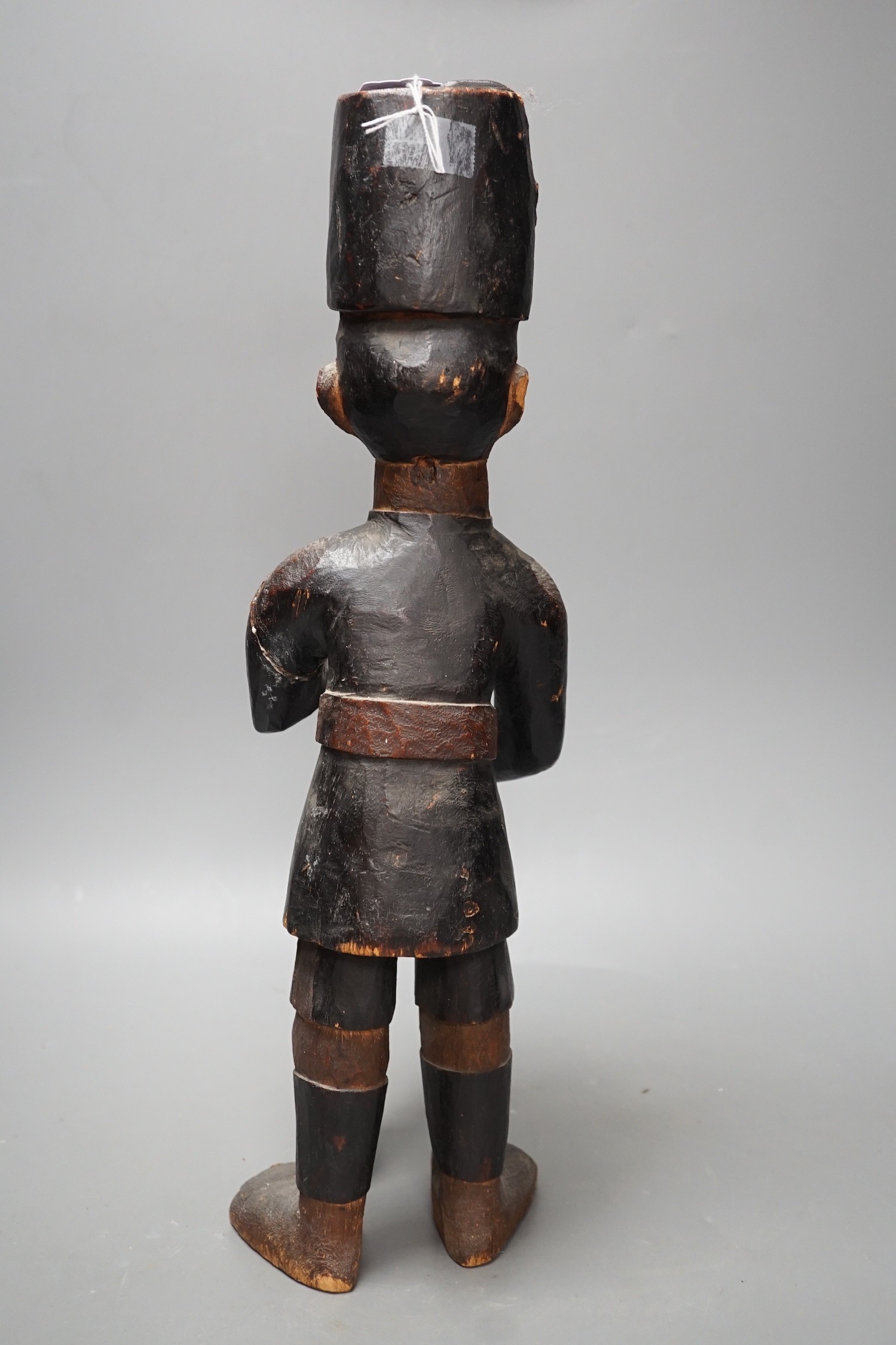 A late 19th century Belgian Congo carved wood figure of a sepoy Height 44 cm